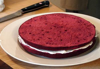 cutting layers of red velvet cake